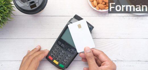 a person holding a credit card next to a calculator
